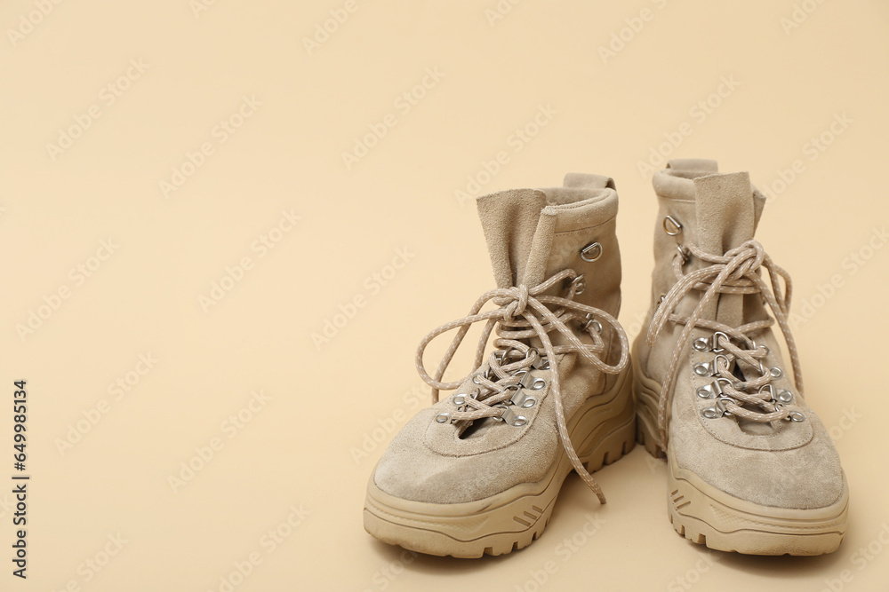 Pair of stylish childs boots on color background