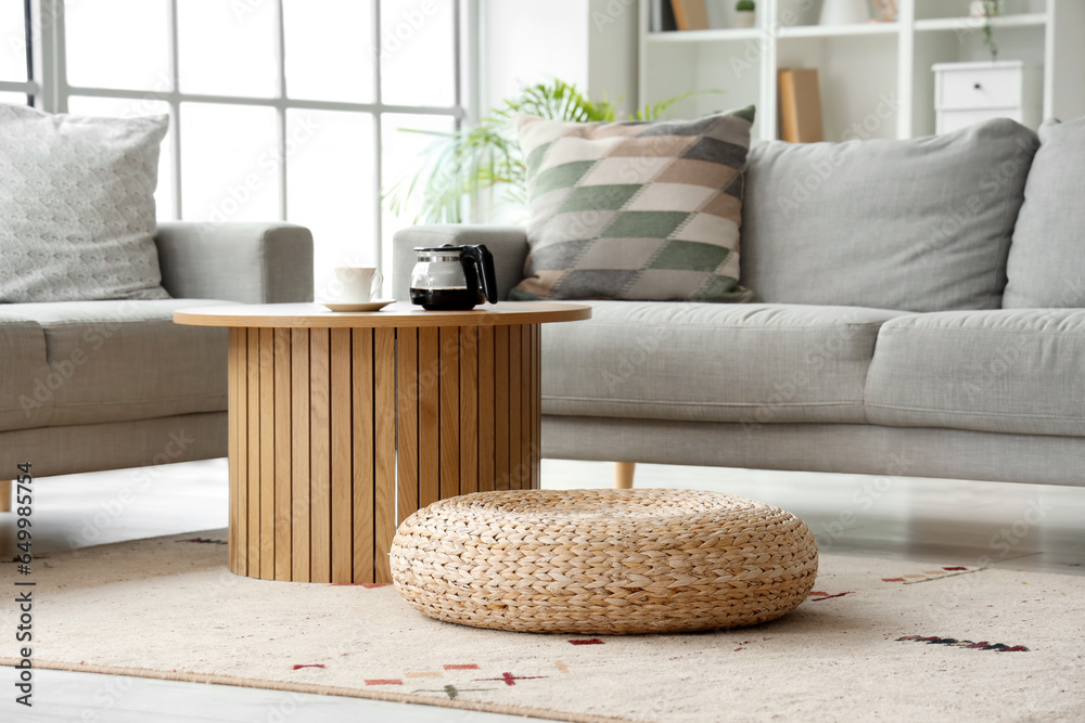 Coffee machine pot with cup on table in living room