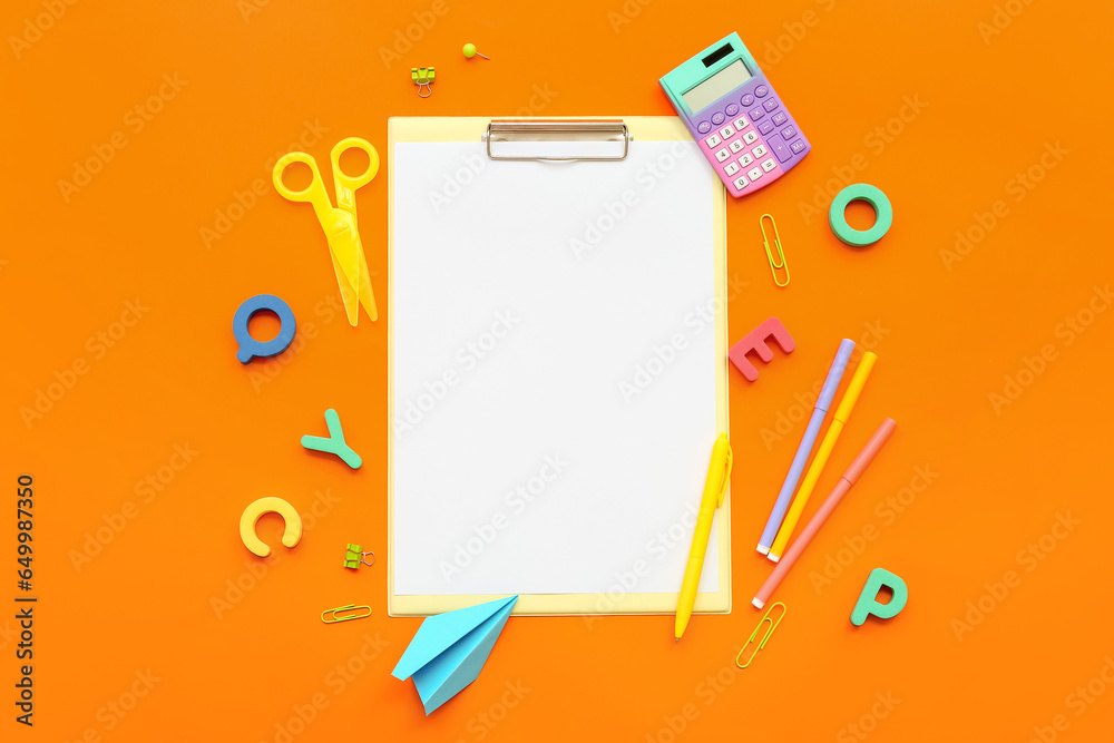 Composition with blank sheet of paper and different stationery on color background