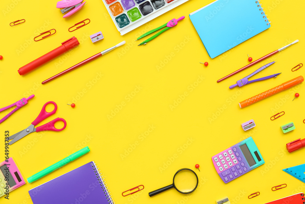 Frame made of different school supplies on yellow background