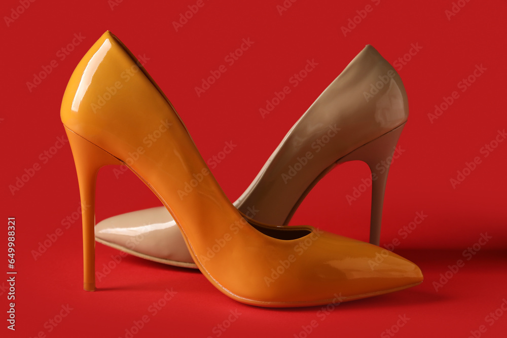 Different stylish high heels on red background