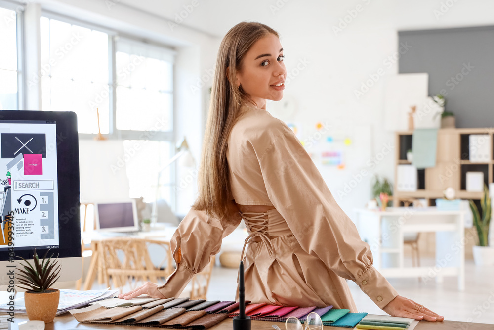 Female interior designer working at table in office