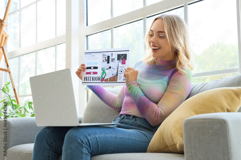 Female interior designer with plan video chatting in office