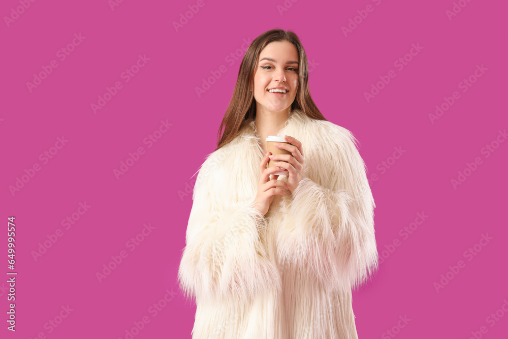 Young woman in fur coat on purple background