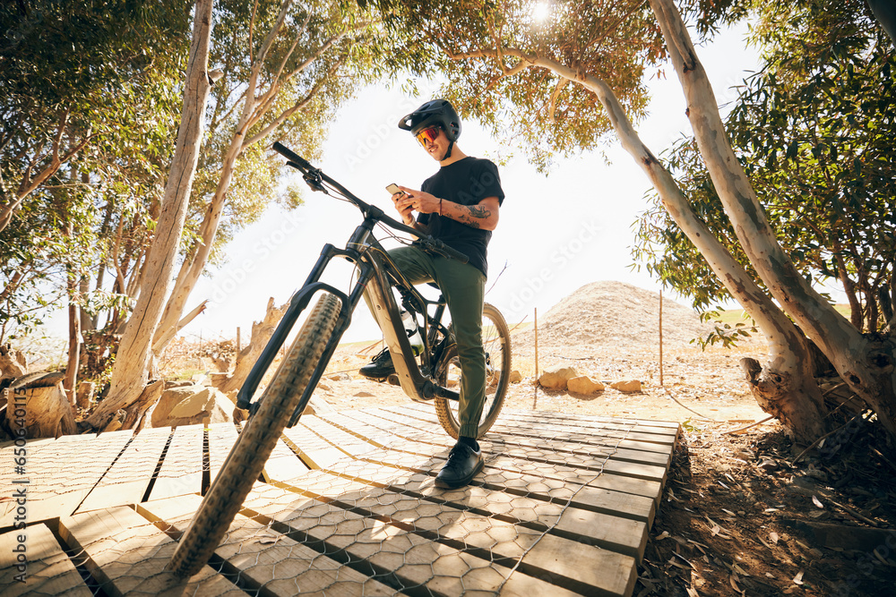 Bicycle, fitness and man with a smartphone, typing and connection with blog, post and social media. Person, biker and cyclist with a cellphone, digital app and influencer with mobile user and contact