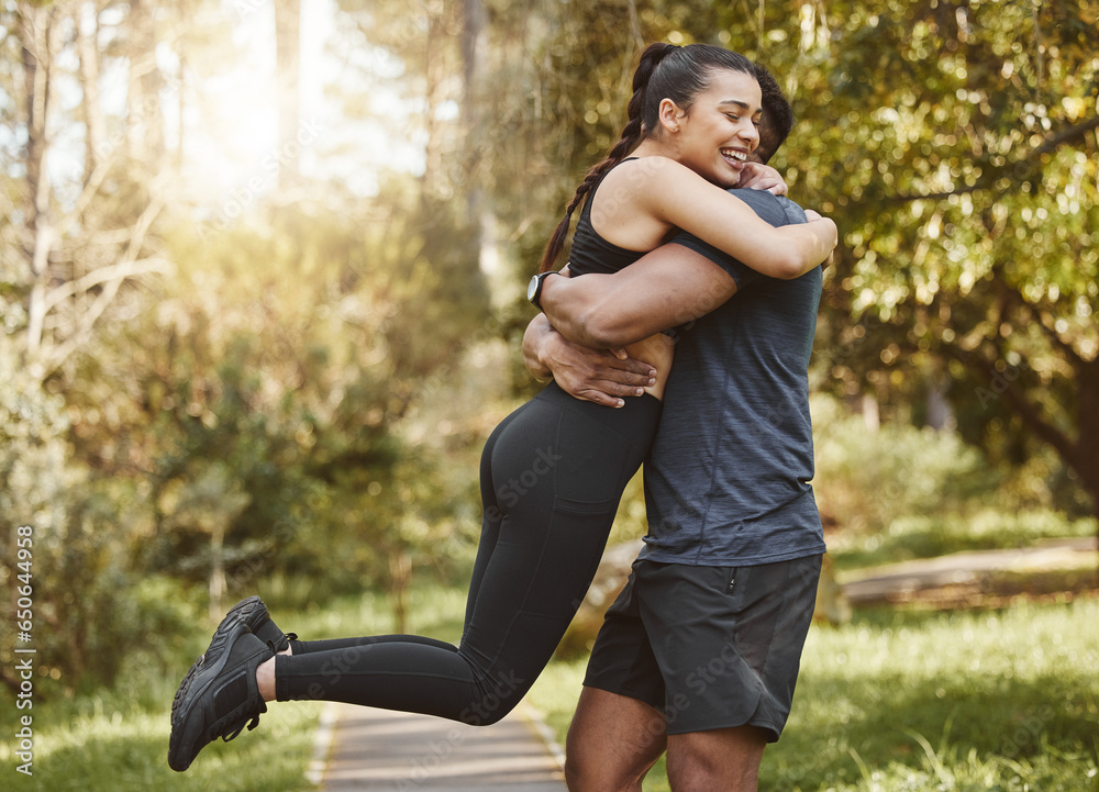 Fitness, nature and couple hug and spinning outdoors for exercise, training and running for cardio workout. Dating, happy and interracial man and woman embrace for wellness, healthy body and sports