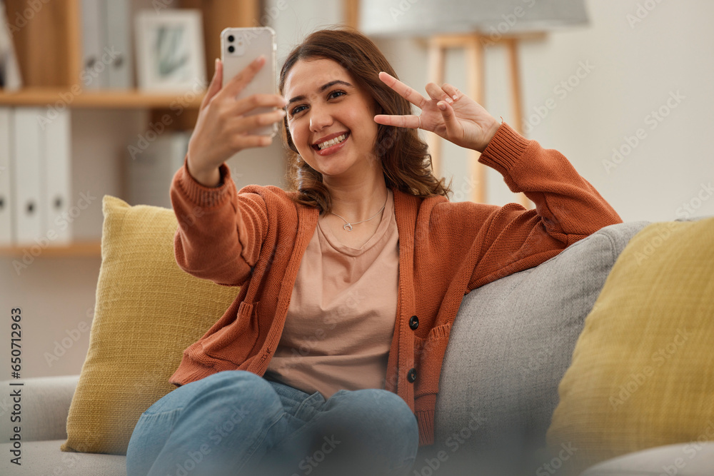 Selfie, peace hand sign and woman on couch, social media post with influencer at home and memory. Smile in picture for content creation, mobile app and relax in living room, V emoji and photography