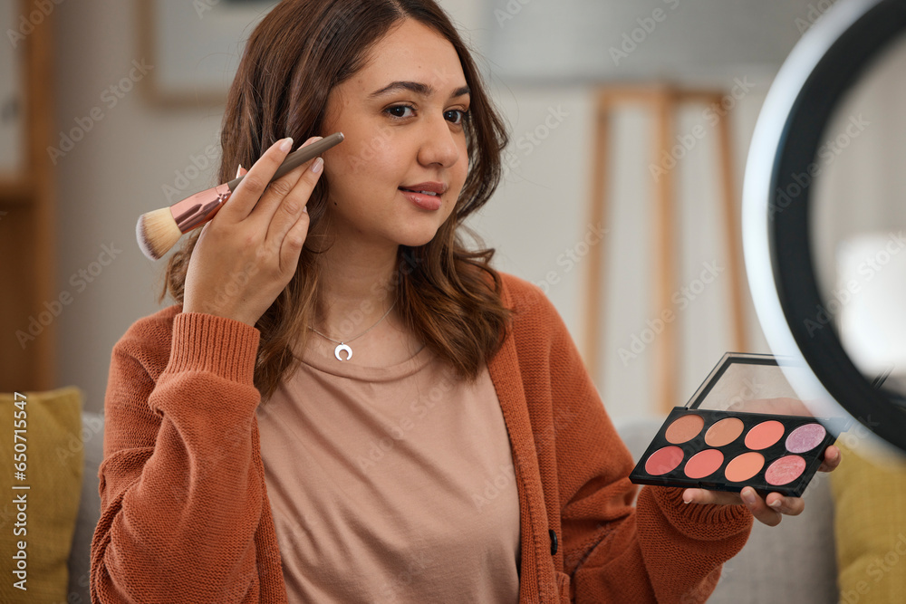 Streaming, makeup and tutorial with a woman influencer in her home to broadcast live content to viewers. Social media, product or review with a young brand ambassador in the living room for cosmetics