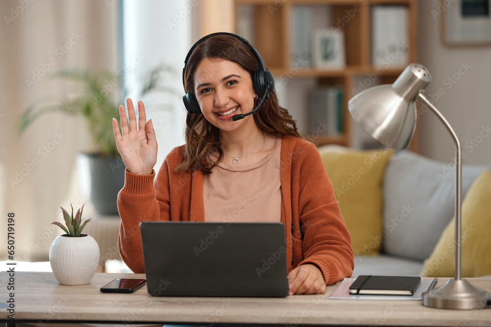 Portrait, wave and remote call center with a woman in her home for customer service consulting. Smile, communication and headset with a happy young freelance employee working on a laptop for support