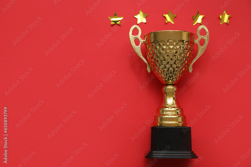 Gold cup with stars on red background