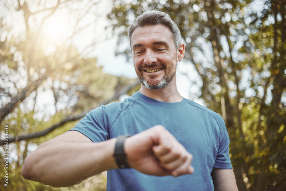 Happy runner man, smart watch and park for check, smile or reading for time, results or fitness in nature. Person, iot clock and monitor for speed, heart rate or smile for exercise, workout or health