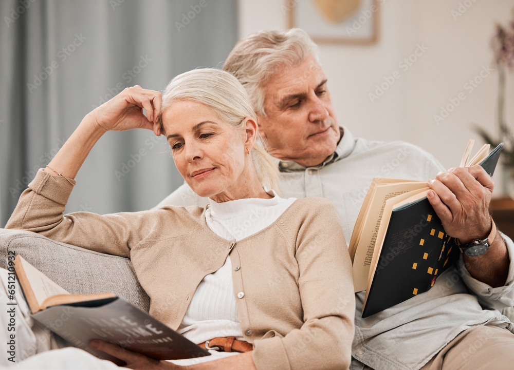 Old couple, relax on sofa and reading book, retirement and support with time together at home. People in living room, knowledge and literature, leisure and hobby with love and comfort with story