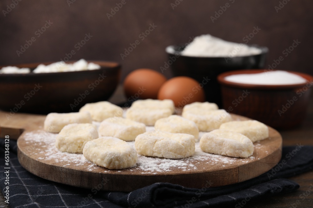 Making lazy dumplings. Board with cut dough and ingredients on wooden table, closeup