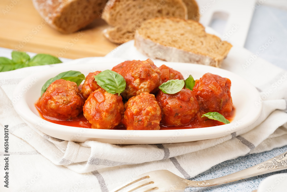 Plate of tasty meat balls with tomato sauce and basil, closeup