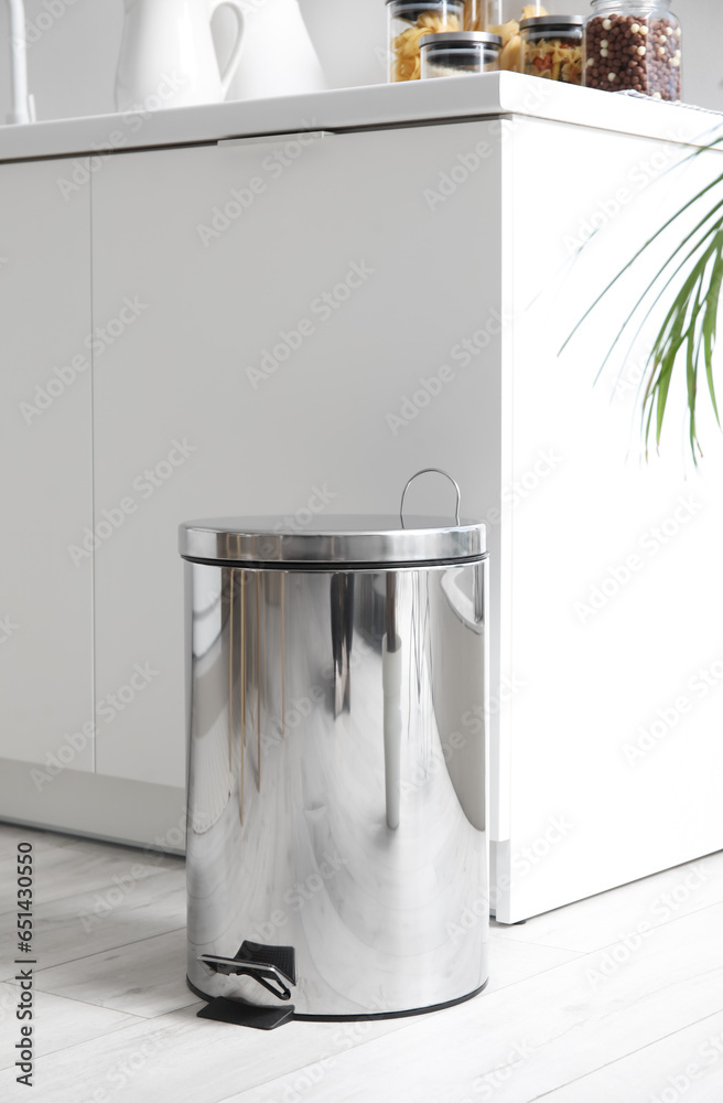 Metallic trash bin in interior of modern kitchen