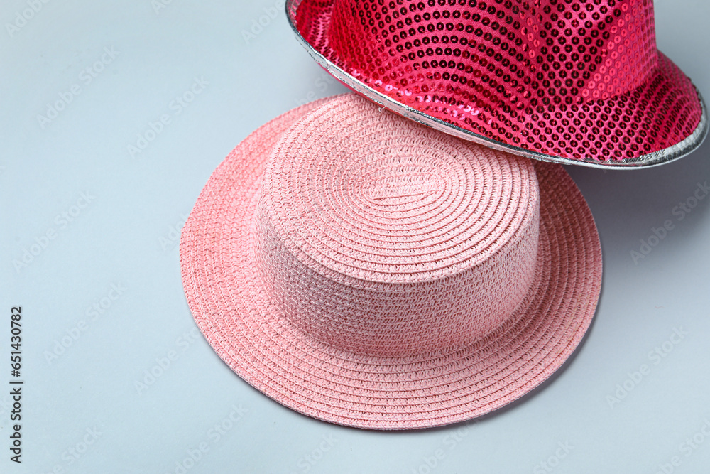 Different pink hats on blue background