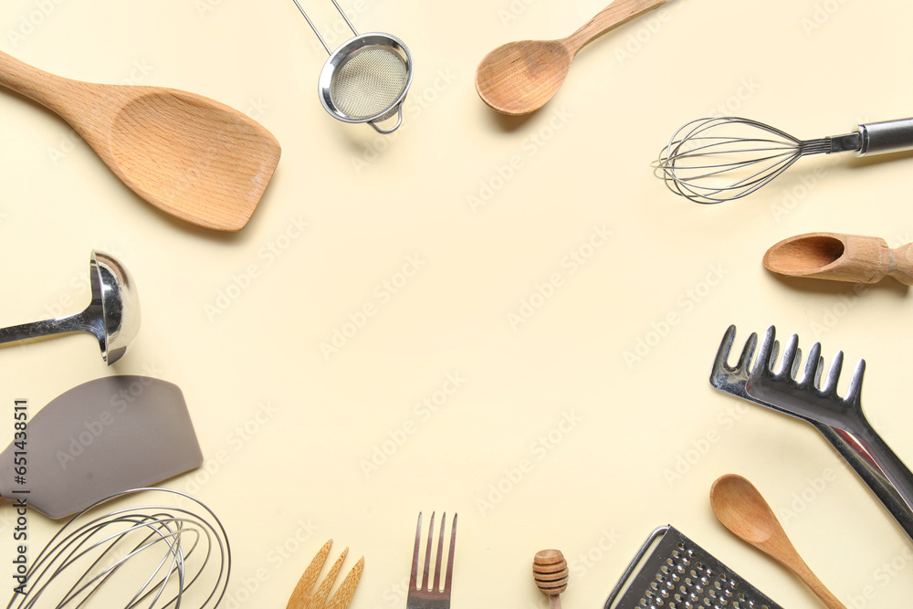 Frame made of different kitchen utensils on color background