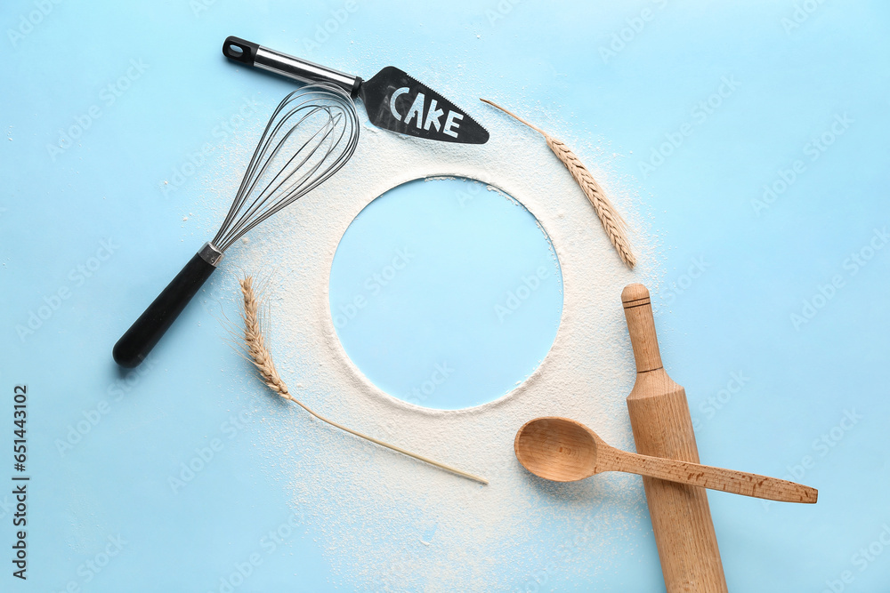 Frame made of sprinkled flour, spikelets and kitchen utensils for preparing bakery on color background