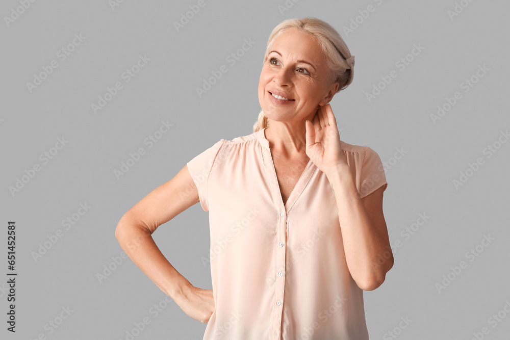 Mature woman on grey background