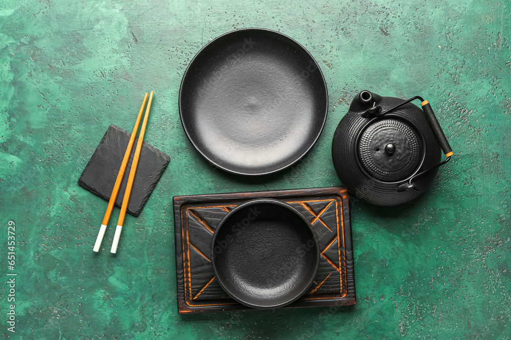 Chinese table setting with teapot on green background