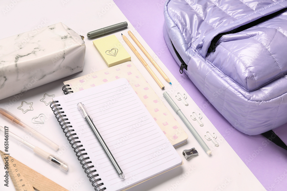 Stylish school backpack with pencil case and different stationery supplies on colorful background