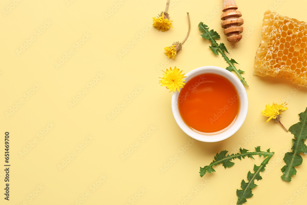 Bowl with tasty honey, honeycomb, dandelion flowers and green leaves on beige background