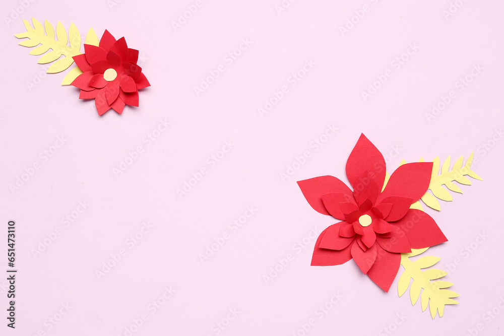 Red origami flowers and leaves on purple background