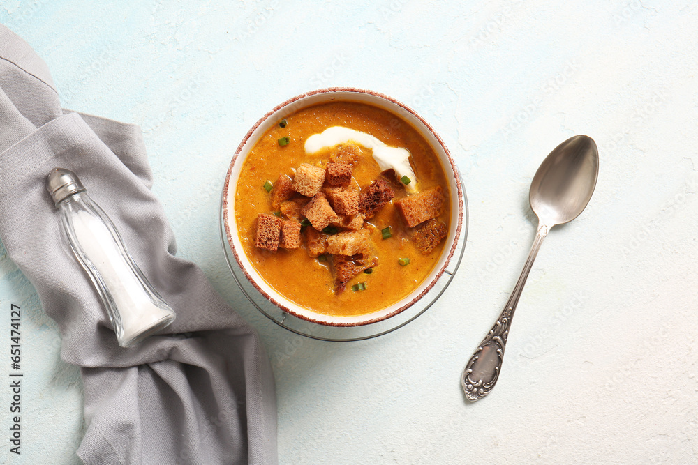 Bowl of tasty cream soup with croutons on white background