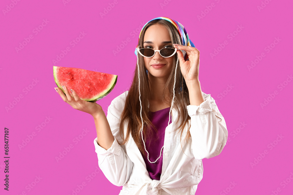 Young woman in sunglasses with fresh watermelon on purple background