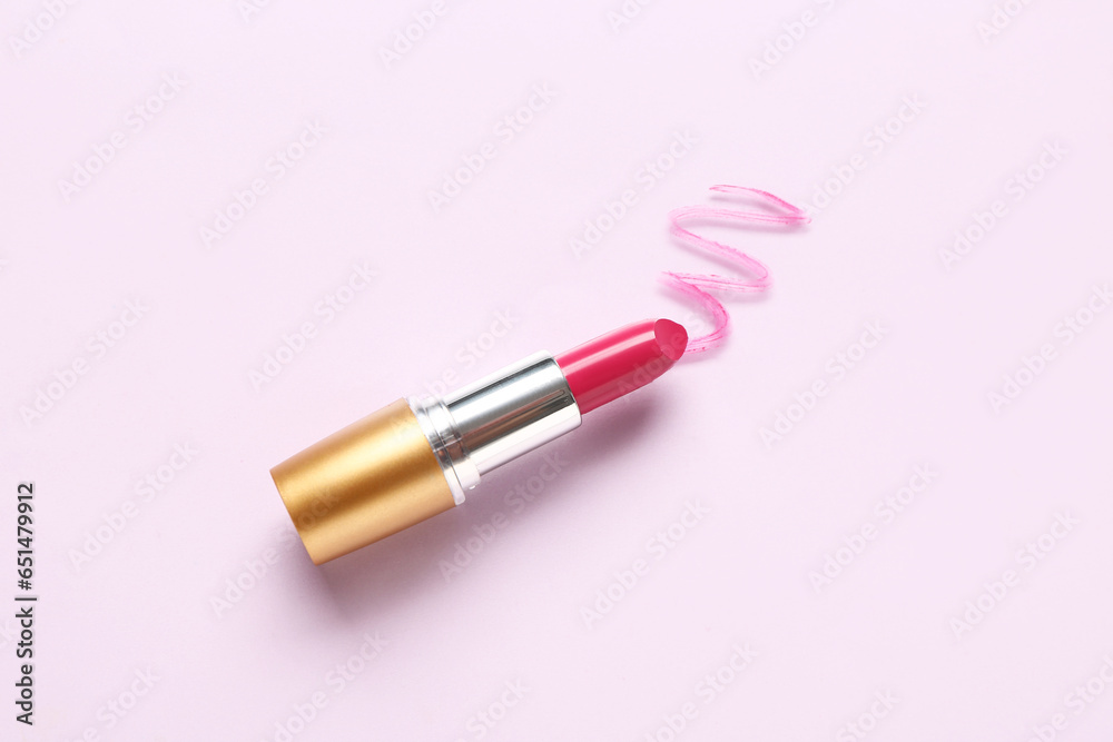 Beautiful lipstick with sample on pink background