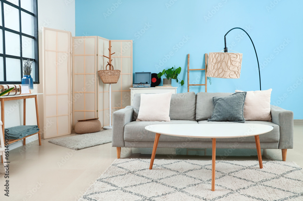 Interior of stylish living room with sofa, table and lamp