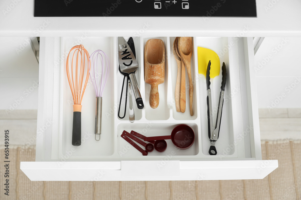 Set of utensils for bakery in drawer at kitchen