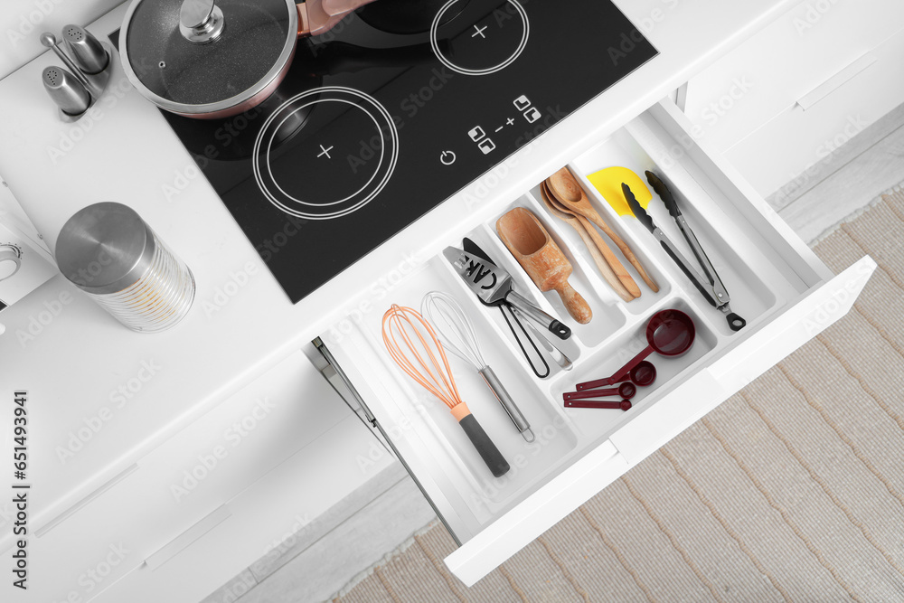 Set of utensils for bakery in drawer at kitchen