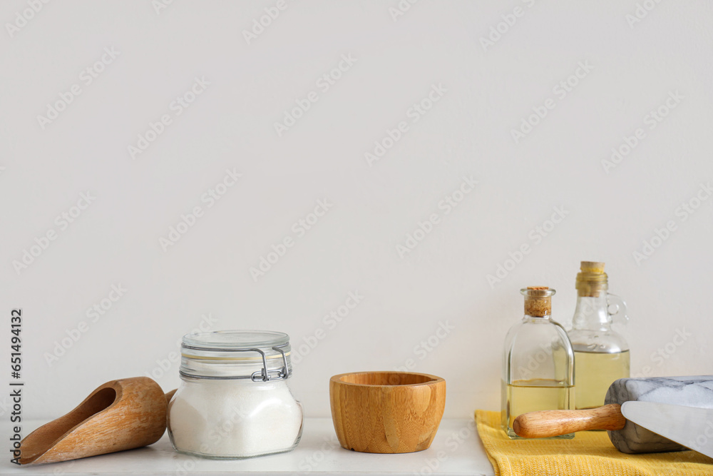 Shelf with ingredients and set of utensils for bakery in kitchen