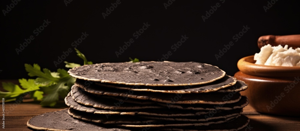 Close up of Guatemalan black corn tortillas cooking on a comal