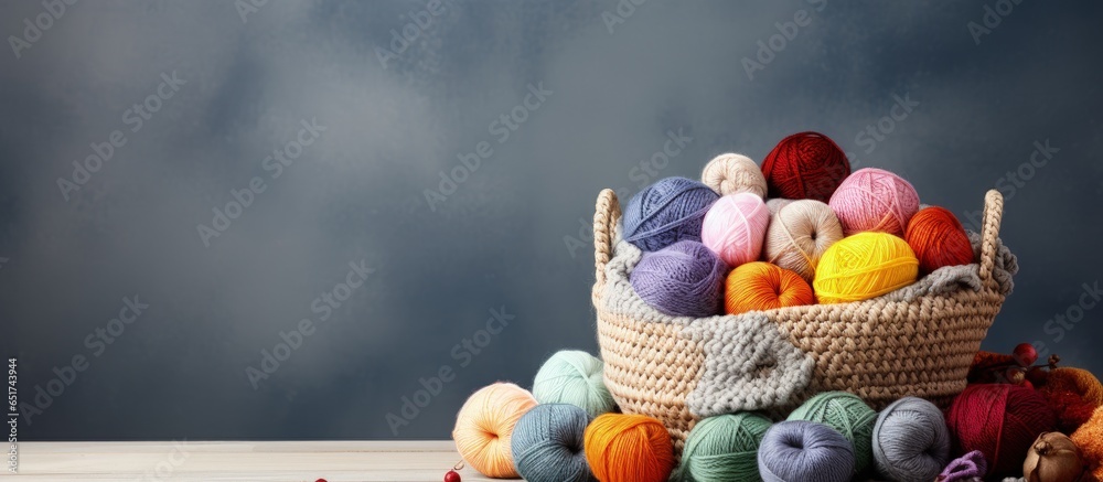 Knitting and crochet create a cozy atmosphere with multicolored yarn in a basket emphasizing the hobby concept with skeins and balls Copy space available