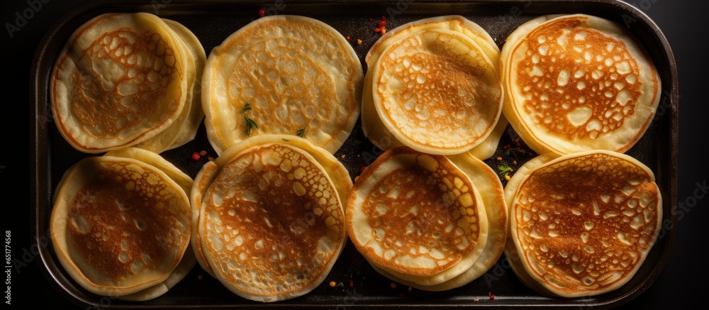 Cooking process of making thin pancakes crepes russian blini step by step frying on black skillet Maslenitsa concept top view ingredients grey background