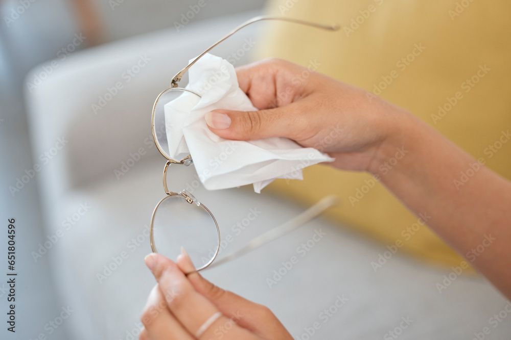 Hands, person and cleaning vision glasses with tissue for lens protection, sight and eye care safety at home. Closeup, cloth and wipe dirt on clear spectacle frames, eyewear and eyesight for wellness