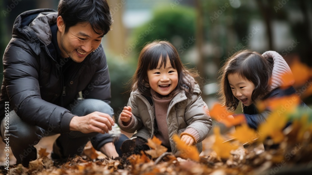 Family playing in leaves in backyard