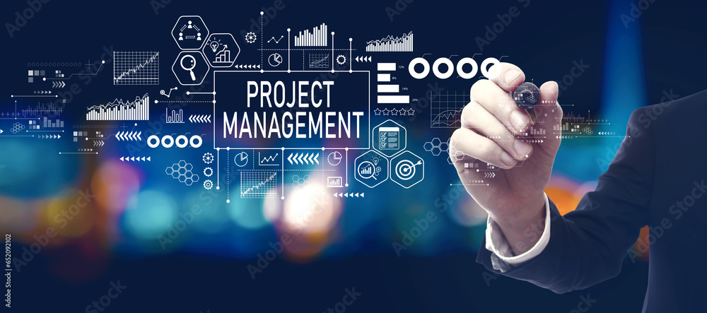 Project management theme with businessman in a city at night