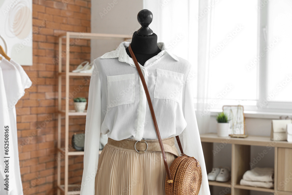 Mannequin with stylish female outfit in boutique, closeup