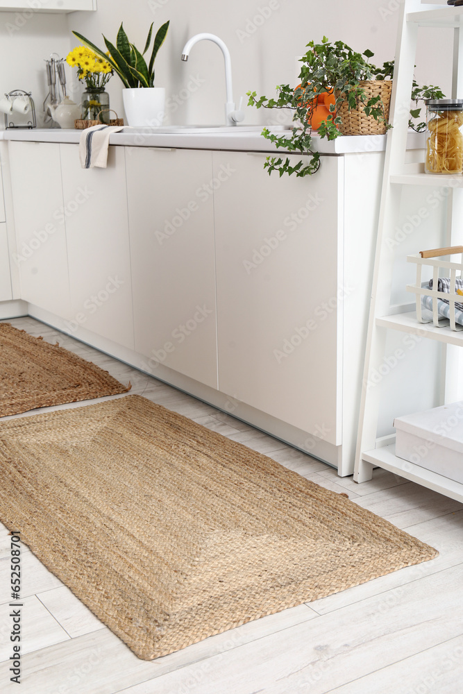 Wicker rug on floor in light kitchen