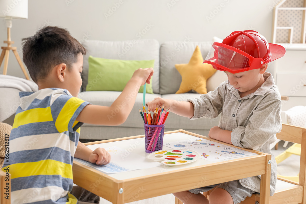 Cute little boys drawing at home