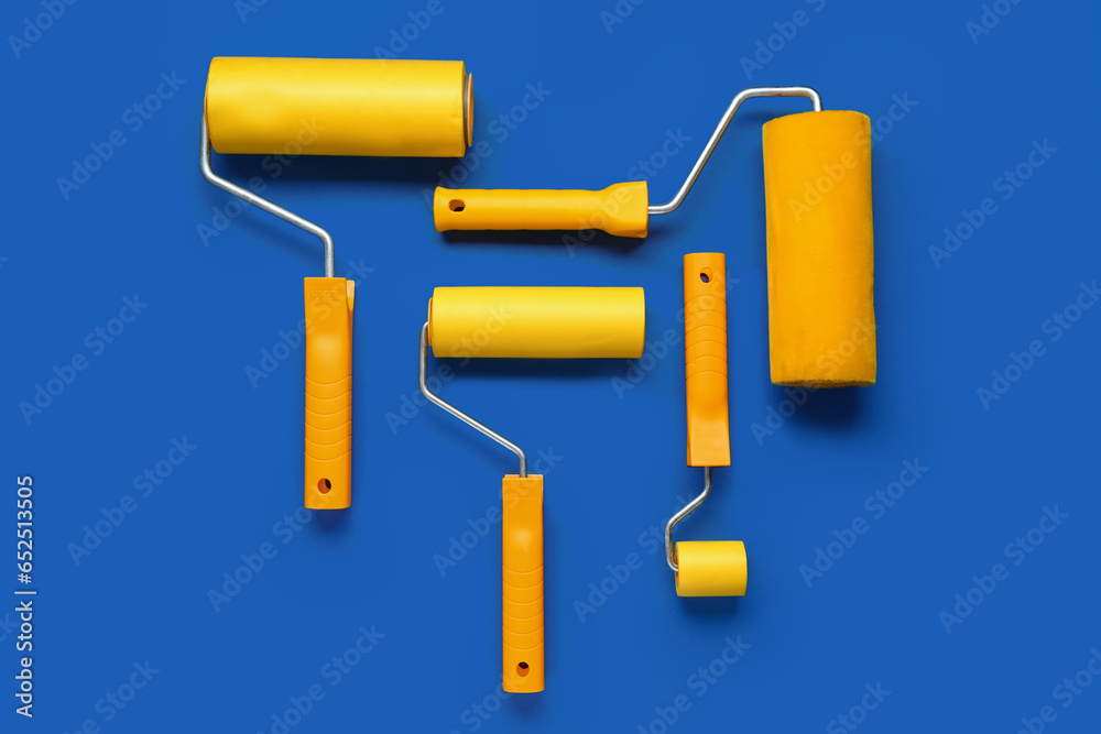 Paint rollers on blue background