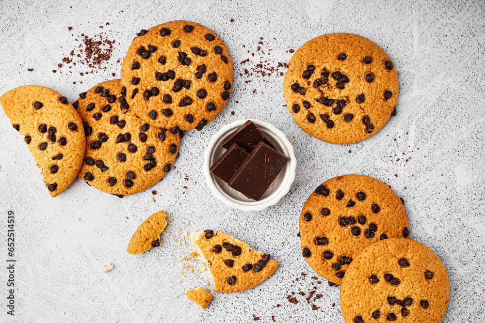 Tasty cookies with chocolate chips on white background