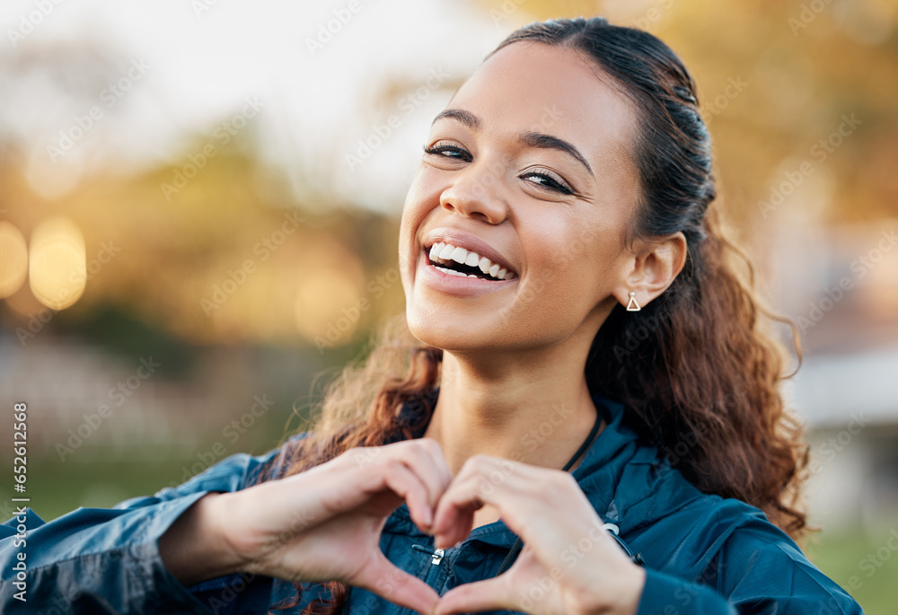 Happy woman, portrait smile and heart hands in nature, fitness or love and care for outdoor sports. Female person or athlete showing romantic emoji, sign or gesture in support for health and wellness