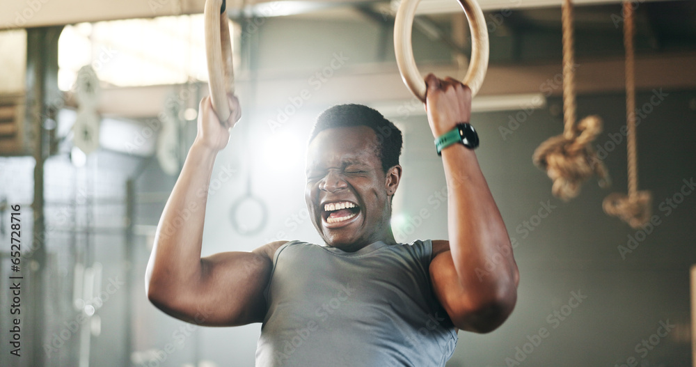 Gym, intense gymnastics and black man doing pull up exercise, arm muscle building or bodybuilding for strength training. Determined, athlete and African person doing fitness, challenge or workout