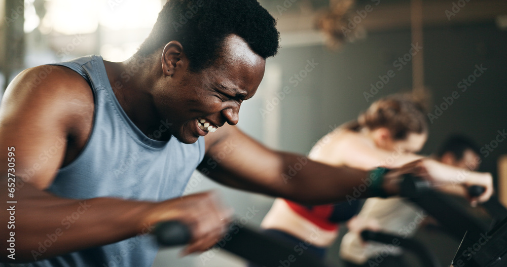 People, diversity and cycling on bicycle at gym in workout, exercise or intense cardio fitness together and motivation. Diverse group burning sweat on machine in healthy body, wellness or lose weight