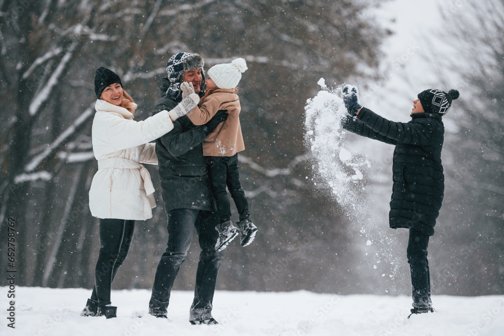 Active people. Happy family is outdoors, enjoying snow time at winter together