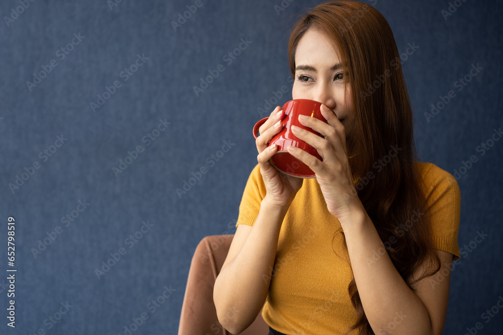 Smile young Asian woman holding a red cup and enjoying drinking warm coffee in the morning, Concept of relaxation in leisure and goods meal breakfast at home.